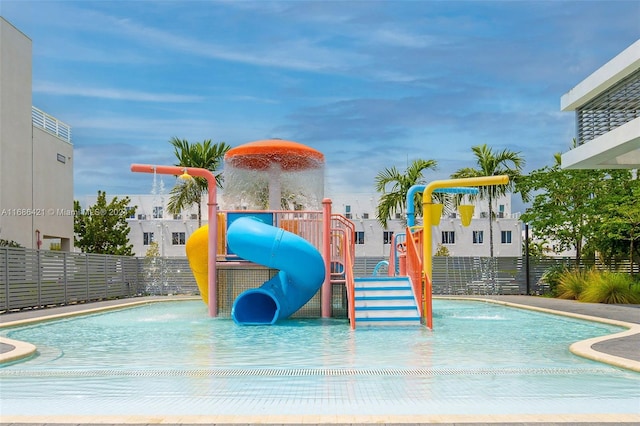 view of jungle gym with pool water feature and a community pool