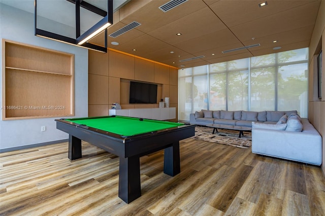 game room featuring light hardwood / wood-style flooring, a wall of windows, and billiards