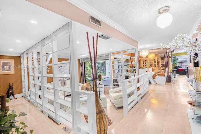 interior space featuring ornamental molding and a textured ceiling