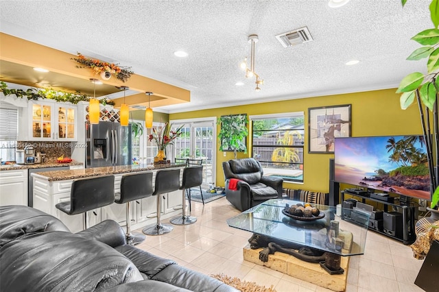 tiled living room with a textured ceiling