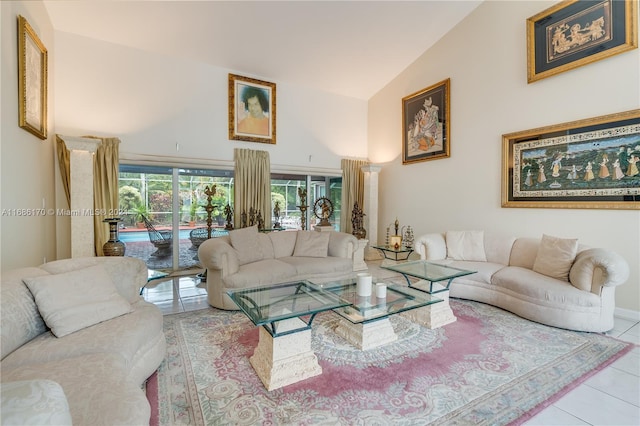 living room with lofted ceiling, light tile patterned floors, and a wealth of natural light