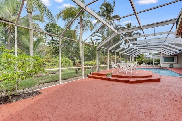 view of pool with a patio area and glass enclosure