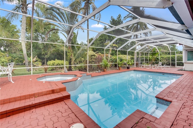 view of swimming pool with a patio area, an in ground hot tub, and glass enclosure