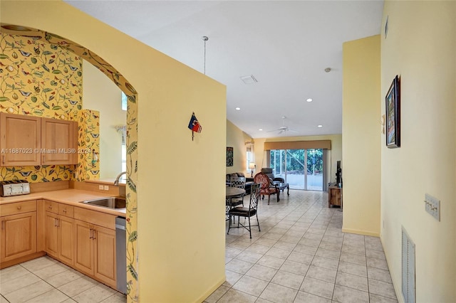 kitchen featuring light tile patterned flooring, a high ceiling, ceiling fan, and sink