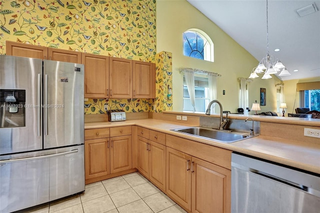 kitchen featuring high vaulted ceiling, sink, light tile patterned flooring, stainless steel appliances, and a chandelier