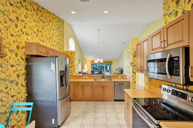 kitchen featuring an inviting chandelier, sink, appliances with stainless steel finishes, light tile patterned flooring, and kitchen peninsula