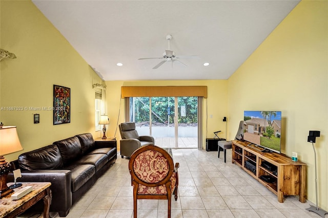 living room featuring vaulted ceiling, ceiling fan, and light tile patterned flooring