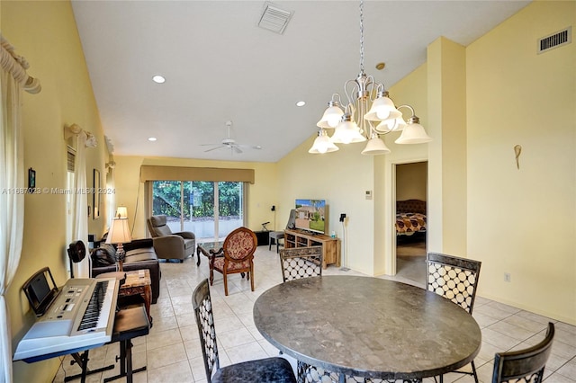 tiled dining area featuring ceiling fan with notable chandelier and lofted ceiling