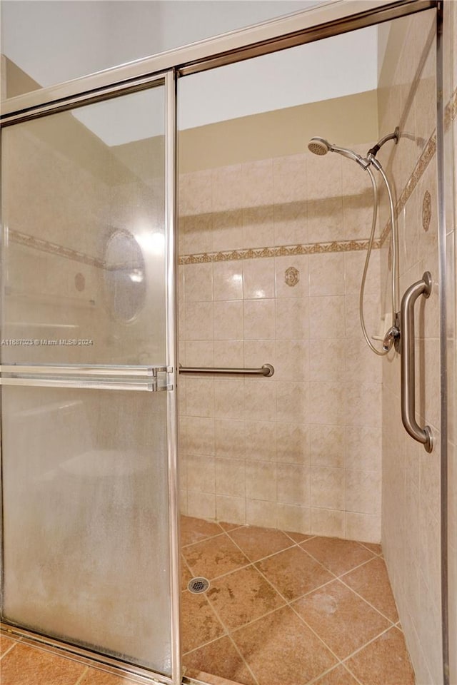 bathroom with tile patterned flooring and walk in shower