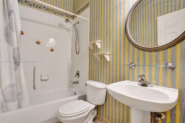 full bathroom with sink, shower / bath combo, and toilet