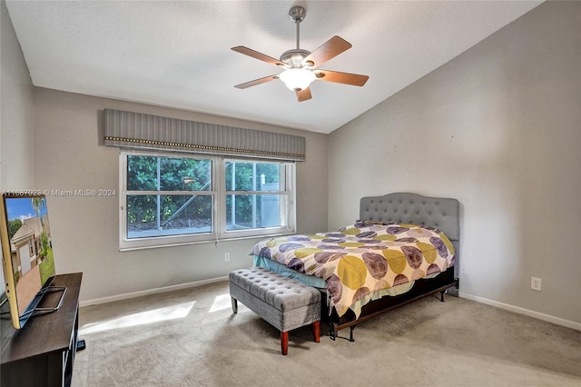 bedroom with light carpet, vaulted ceiling, and ceiling fan