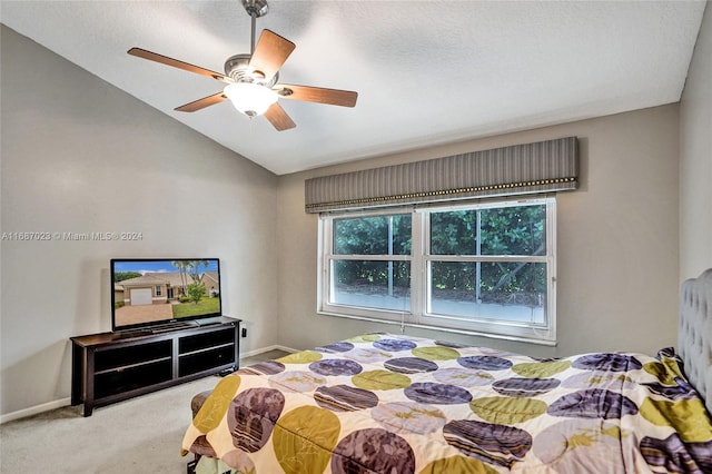 carpeted bedroom featuring a textured ceiling, ceiling fan, and lofted ceiling