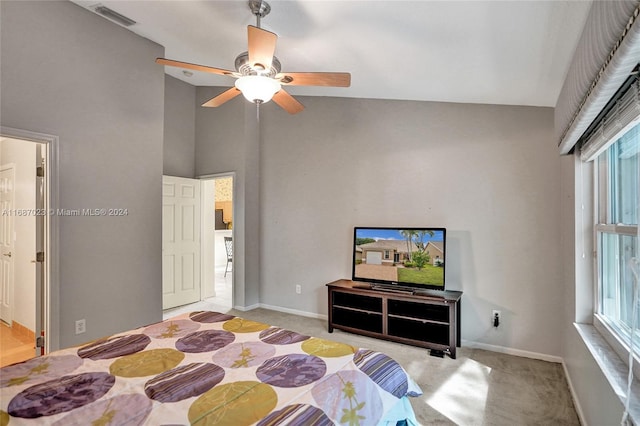 carpeted bedroom with high vaulted ceiling, ceiling fan, and connected bathroom