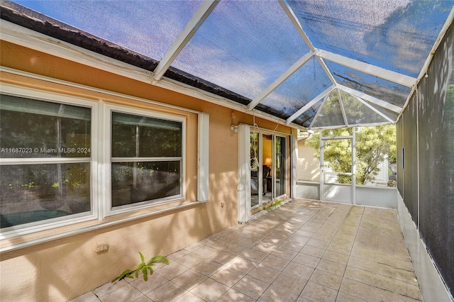 unfurnished sunroom featuring vaulted ceiling