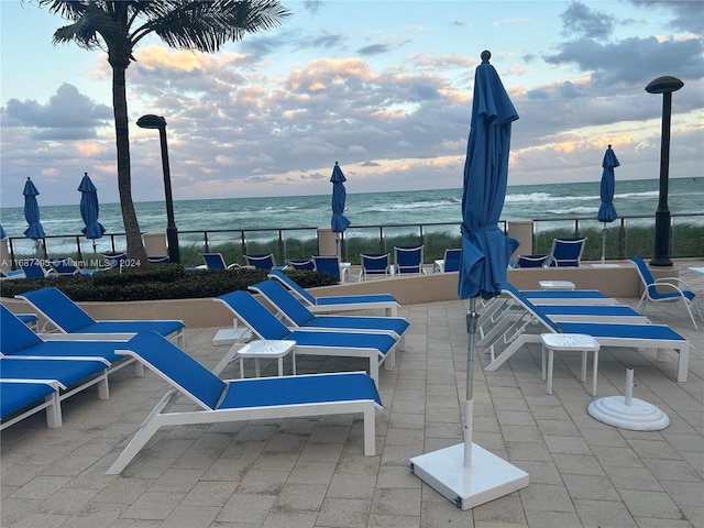 view of patio featuring a water view and a view of the beach