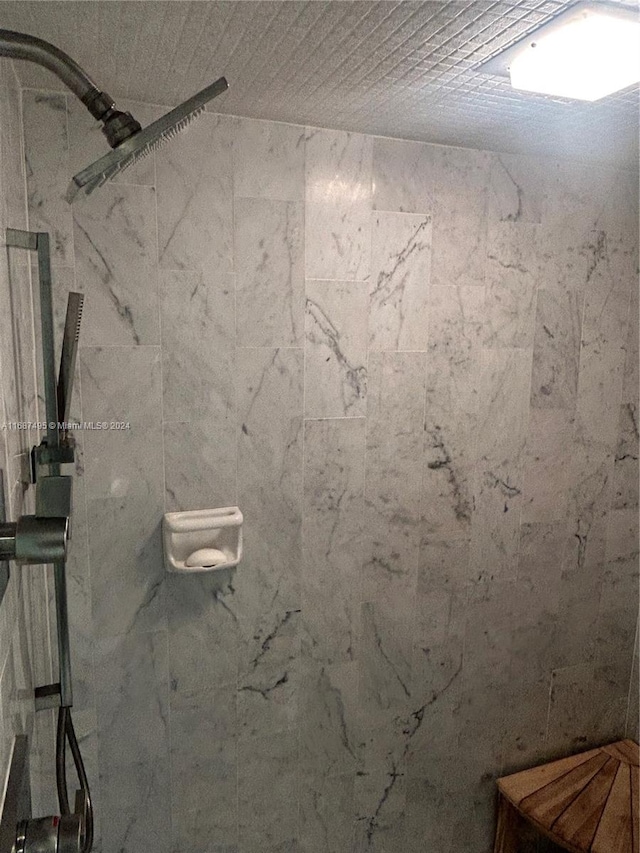 bathroom with tiled shower