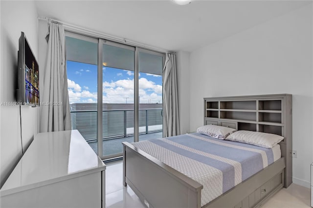 bedroom with a wall of windows and access to outside