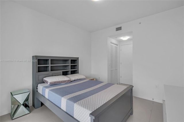 bedroom with a closet and light tile patterned floors