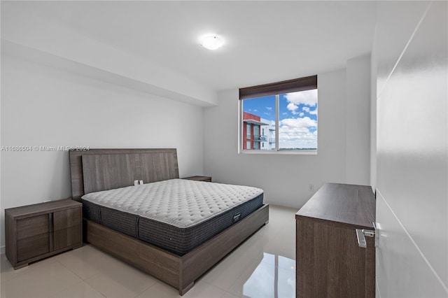 bedroom with light tile patterned floors