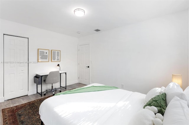 bedroom with a closet and hardwood / wood-style floors