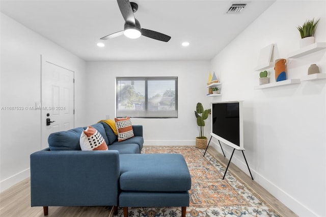 living room featuring wood-type flooring and ceiling fan