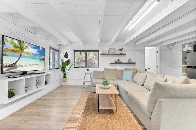 living room with light hardwood / wood-style flooring and beamed ceiling