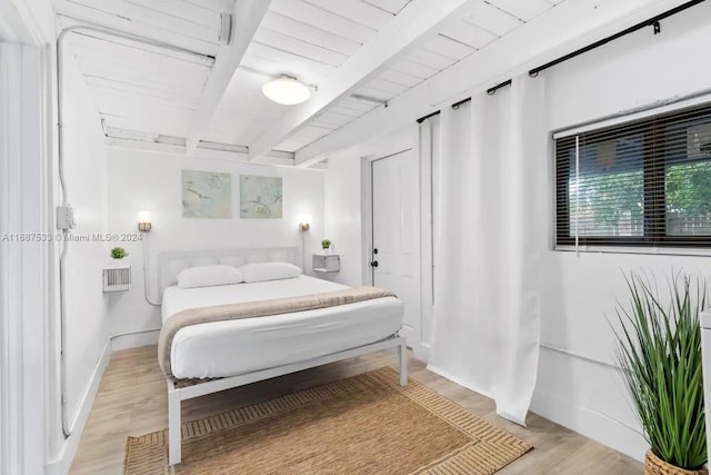 bedroom featuring wooden ceiling, beamed ceiling, and light wood-type flooring