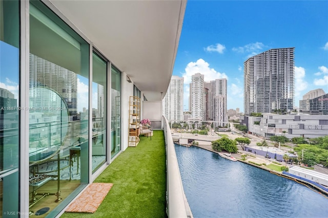 view of pool featuring a lawn and a water view