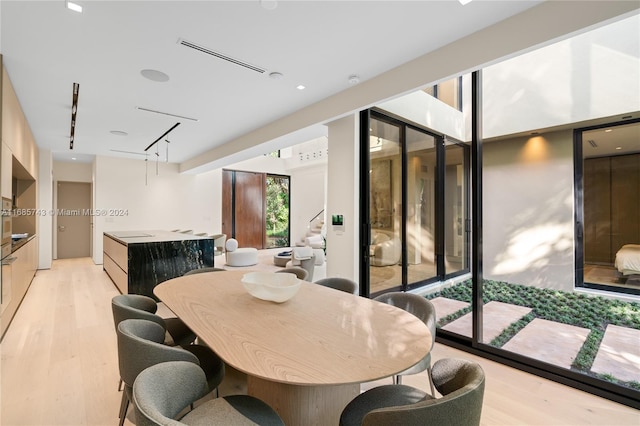 dining space featuring light wood-type flooring