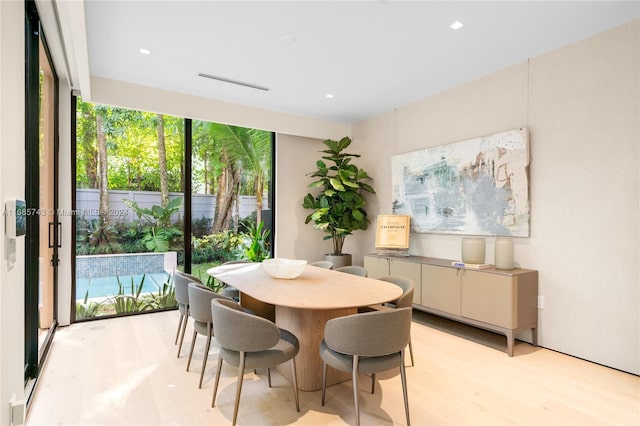 dining space with light hardwood / wood-style flooring