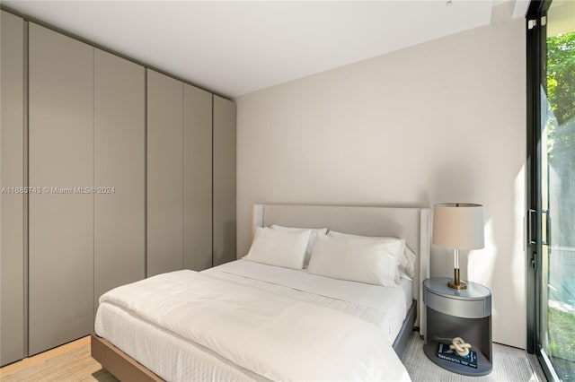 bedroom featuring light wood-type flooring and multiple windows