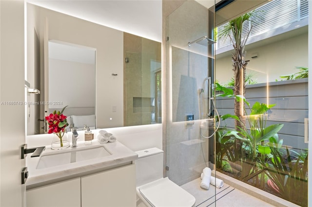 bathroom featuring vanity, toilet, and an enclosed shower