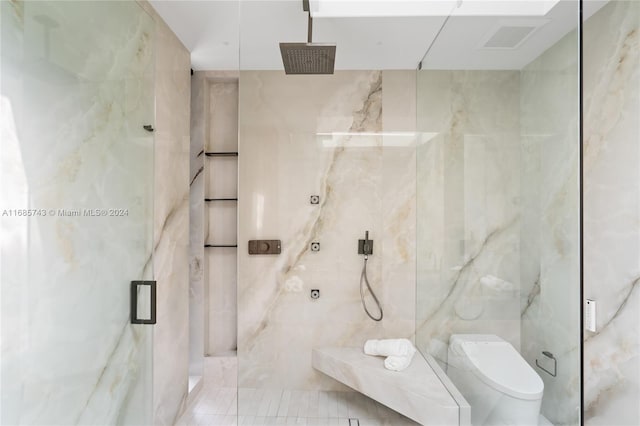 bathroom with tile patterned floors, toilet, an enclosed shower, and tile walls