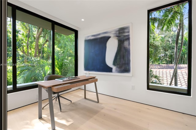 home office with light hardwood / wood-style floors