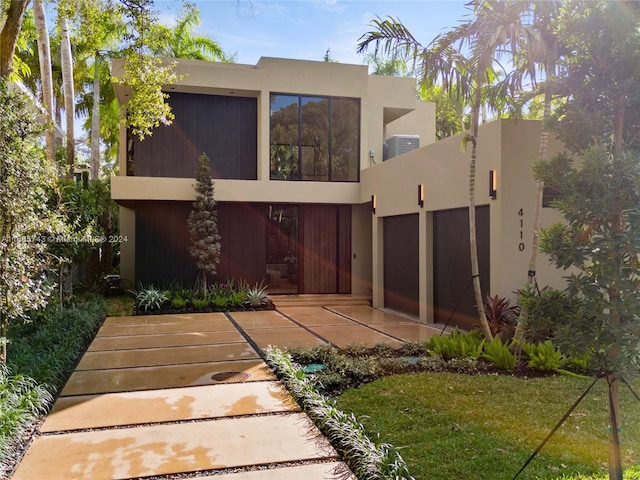 back of house with a yard and central AC unit