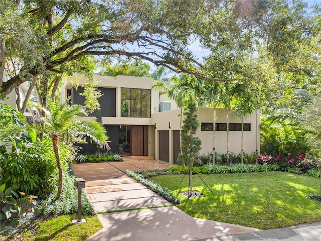 modern home featuring a front lawn