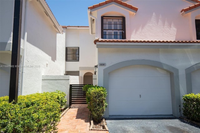 mediterranean / spanish home featuring a garage