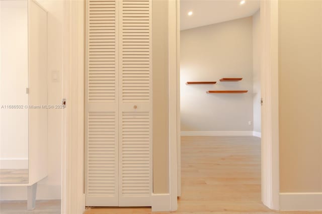 corridor featuring light wood finished floors, recessed lighting, and baseboards