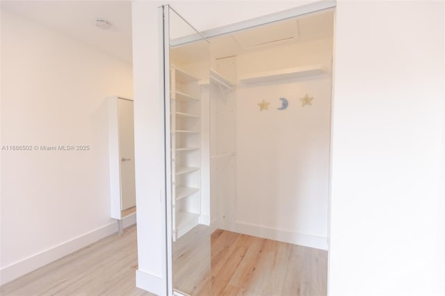 bathroom with baseboards and wood finished floors