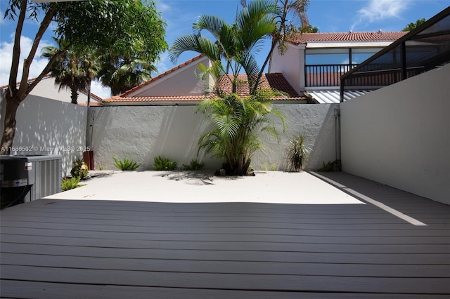 deck featuring central AC unit and fence