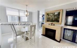 1833 S Ocean Dr Unit Ph1, Hallandale Beach, FL 33009 - dining space featuring a fireplace and a chandelier