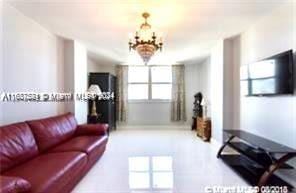 1833 S Ocean Dr Unit Ph1, Hallandale Beach, FL 33009 - living area with a chandelier and baseboards