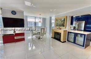 1833 S Ocean Dr Unit Ph1, Hallandale Beach, FL 33009 - kitchen featuring tile patterned floors, freestanding refrigerator, a chandelier, and a fireplace