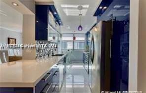 1833 S Ocean Dr Unit Ph1, Hallandale Beach, FL 33009 - kitchen featuring blue cabinetry