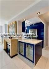 1833 S Ocean Dr Unit Ph1, Hallandale Beach, FL 33009 - kitchen featuring blue cabinetry, light tile patterned flooring, light countertops, and recessed lighting