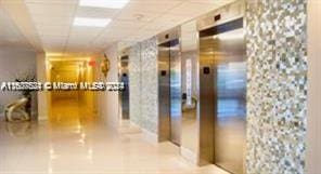 1833 S Ocean Dr Unit Ph1, Hallandale Beach, FL 33009 - hallway featuring elevator and a drop ceiling