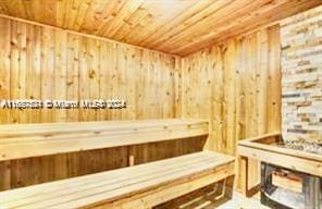 view of sauna featuring wooden walls and wood ceiling