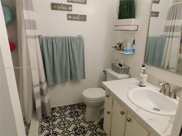 bathroom featuring tile patterned floors, a shower with shower curtain, toilet, and vanity