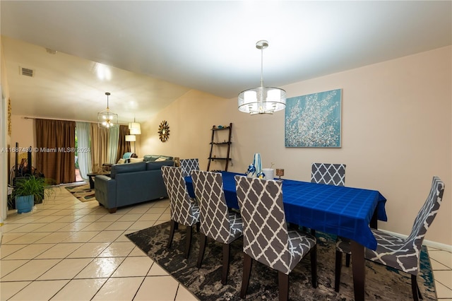 dining area with an inviting chandelier and light tile patterned floors