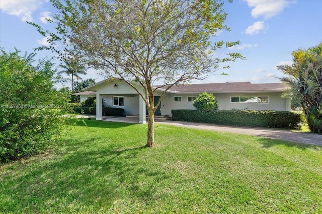 back of house with a lawn